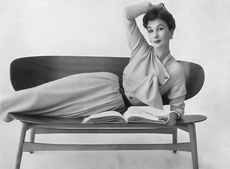 #44 Barbara Goalen in oatmeal wool jersey dress with a side-fastened line by Henry Gowns, 1953.