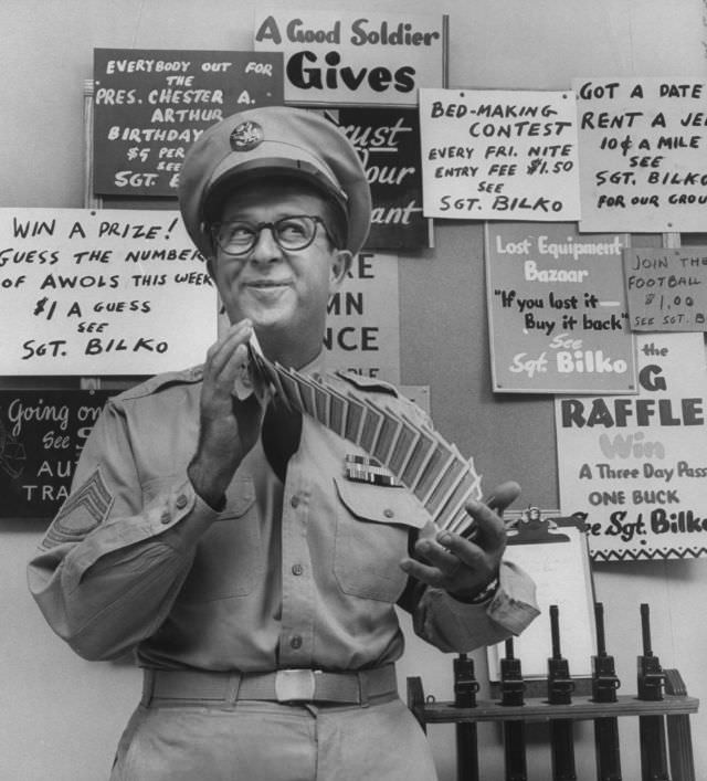 #11 Comedian Phil Silvers, in the character of Sgt. Bilko, shuffling cards on his television show.