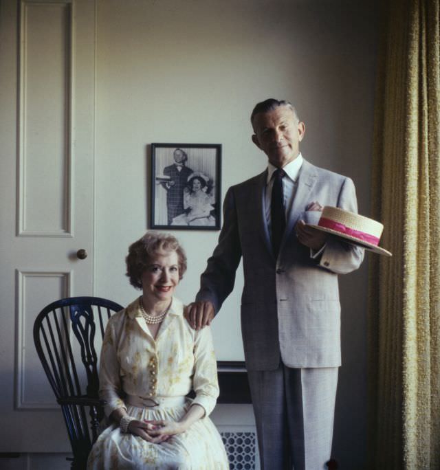 #12 Gracie Allen and George Burns, 1958. On the wall behind them is a photo of the pair, in a similar pose, from their days as vaudeville performers.