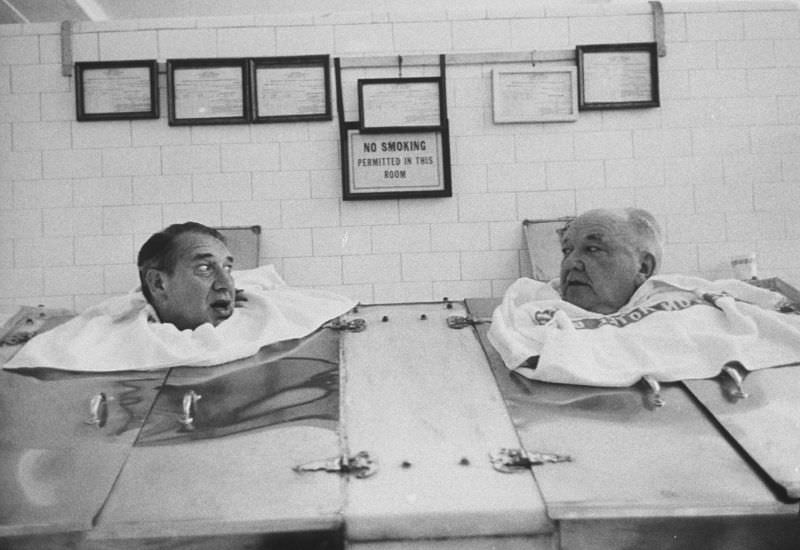 #31 Comedian Henry Youngman (left) in a steam cabinet in Hot Springs, Arkansas, 1960.