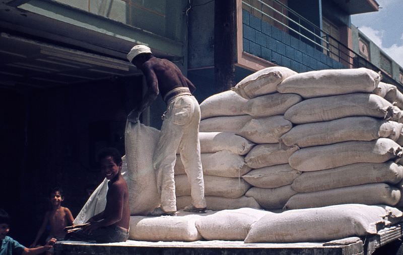 #11 Man unloading flour sacks from his truck, Santa Clara, 1970s