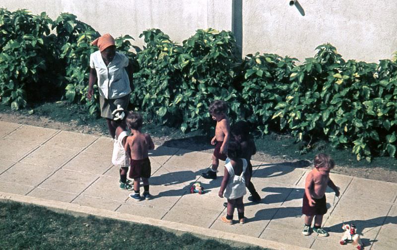 #18 A teacher taking care of children playing with their toys, Cuba, 1976
