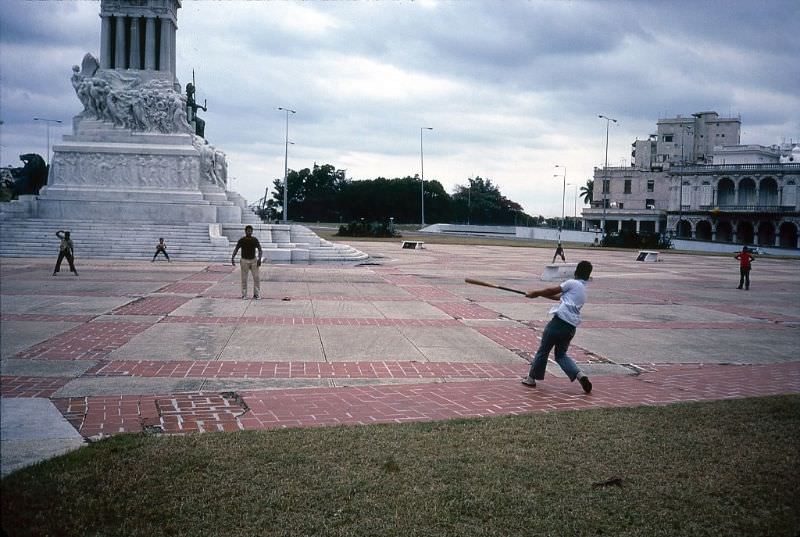 #62 A group of boys play baseball on the plaza near the Monument To Maximo Gomez, Havana.