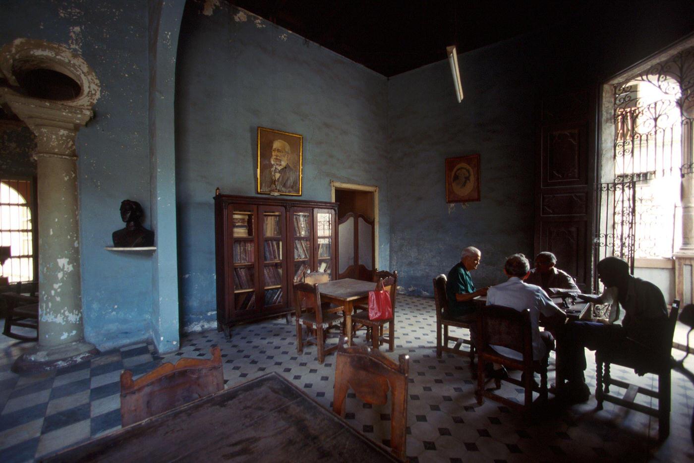 #33 Four Cuban men playing dominoes at a senior center in Camaguey, Cuba, 1990.