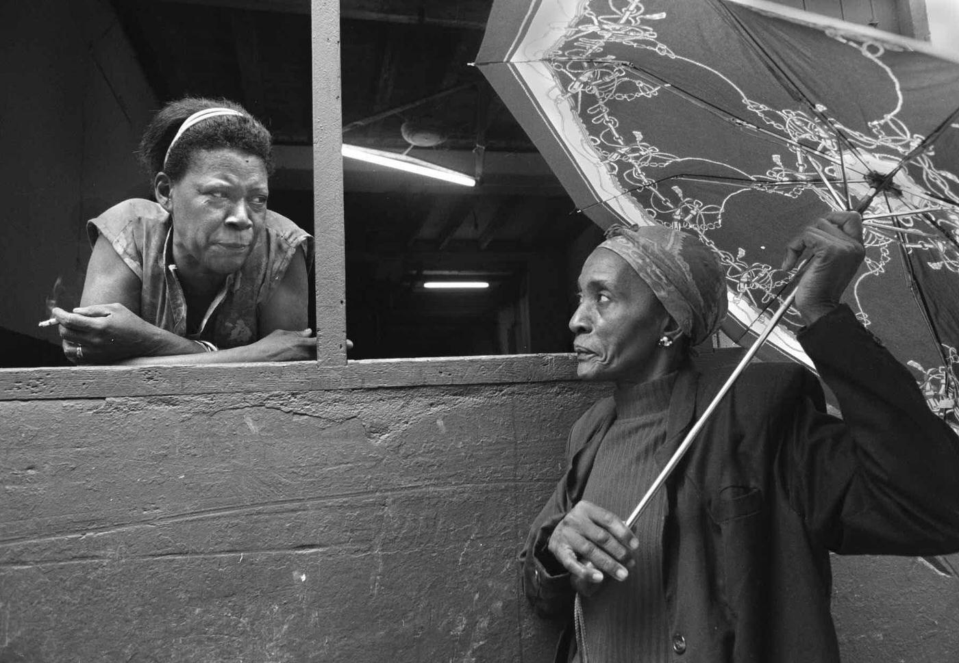 #108 Two women having a morning chat at a window near Old Havana, Cuba, January 27, 1998.