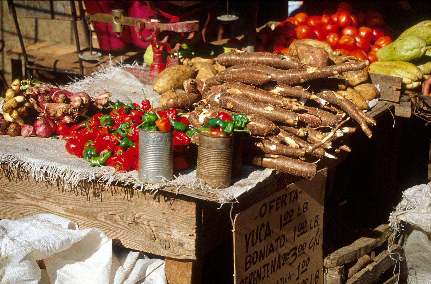 #7 Food market in Santiago de Cuba selling yucca, sweet potatoes, chilies, and vegetables, 1990s.