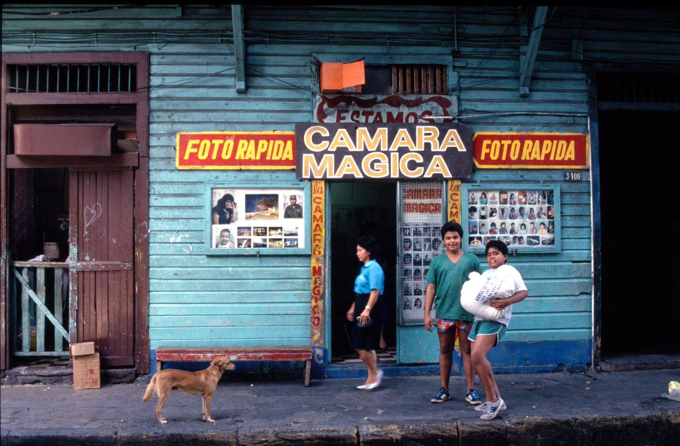 #65 Locals standing outside a photo shop in downtown Havana, Cuba, 1991.