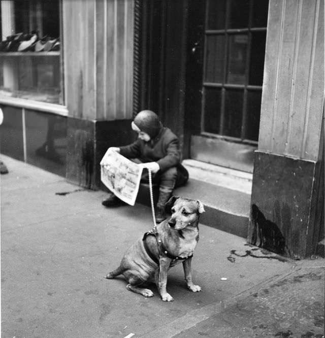 #25 A boy read newspaper comics while his leash-tethered mutt waited, New York City, 1944.