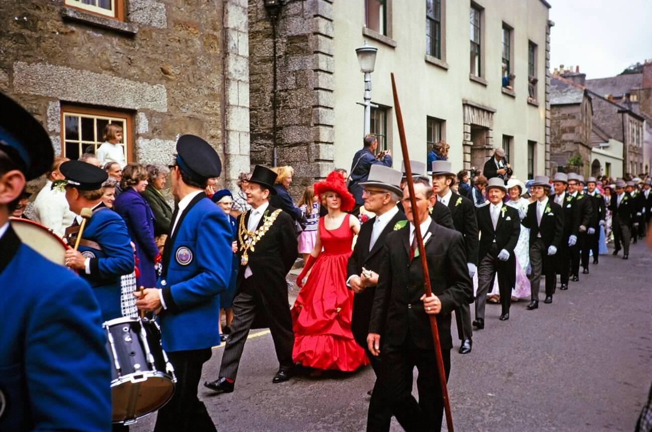 #37 Flora Day, Crowds watch couples led by mayor parade for the Furry dance in the streets of the town