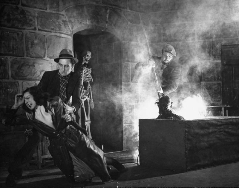 #1 Actors demonstrating use of the acid vat to make skeletons in production trick at the Grand Guignol Theater.