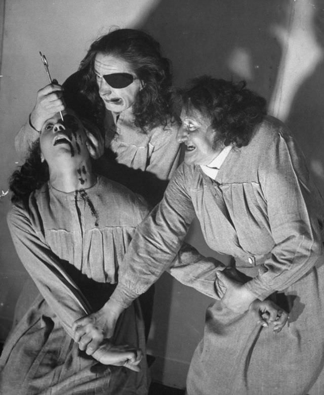 #13 Actors engaging in an eye-gouging scene in a bloody melodrama production at the Grand Guignol Theater.
