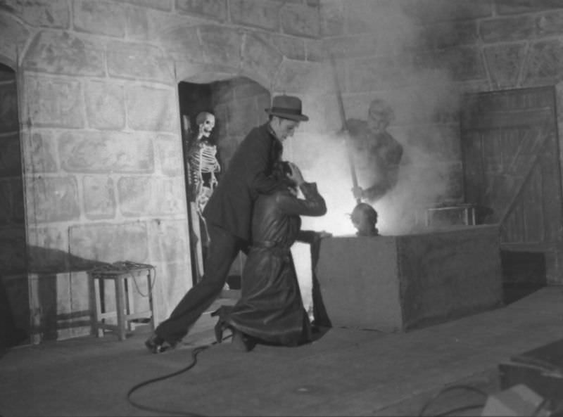 #5 Actors demonstrating use of the acid vat to make skeletons in production trick at the Grand Guignol Theater.