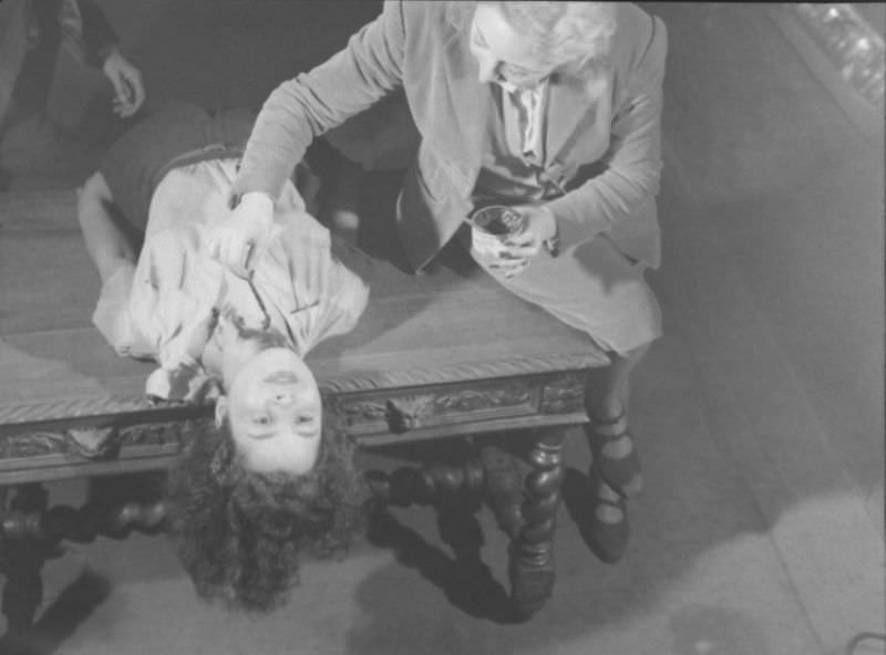 #8 Actor dramatizing the realistic stabbing trick in production at the Grand Guignol Theater.