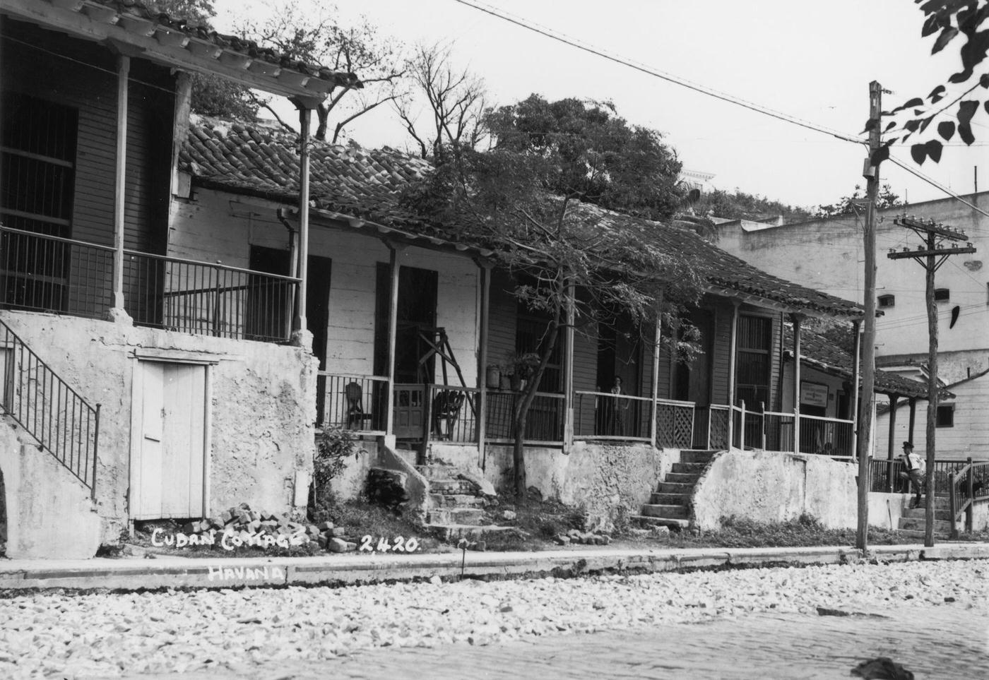 #21 Run-down, single-storey houses on a street in Havana, capital of Cuba, 1938