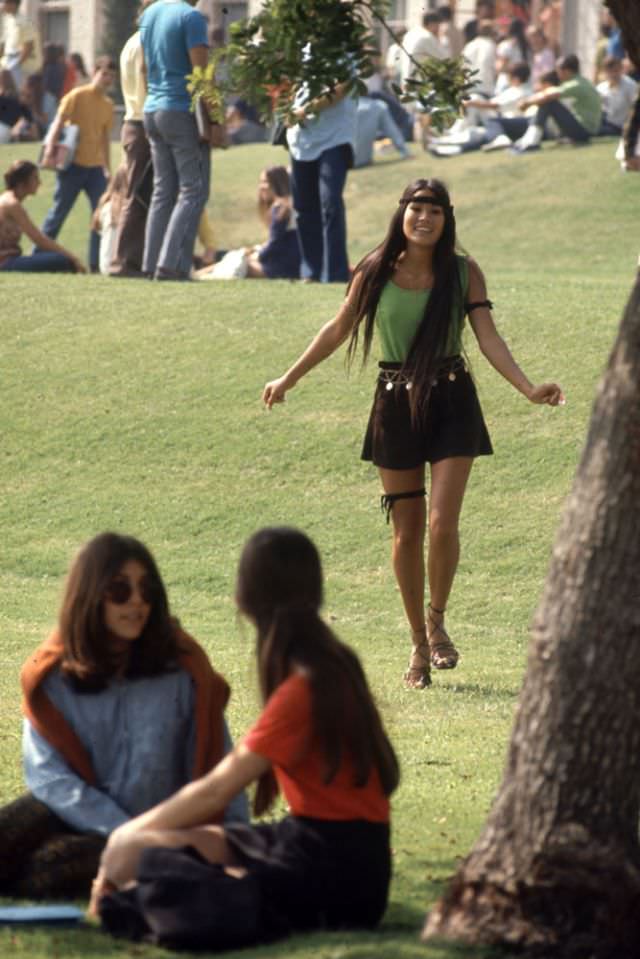 #7 A Southern California high school student walked toward classmates while wearing the “Mini Jupe” skirt, 1969.