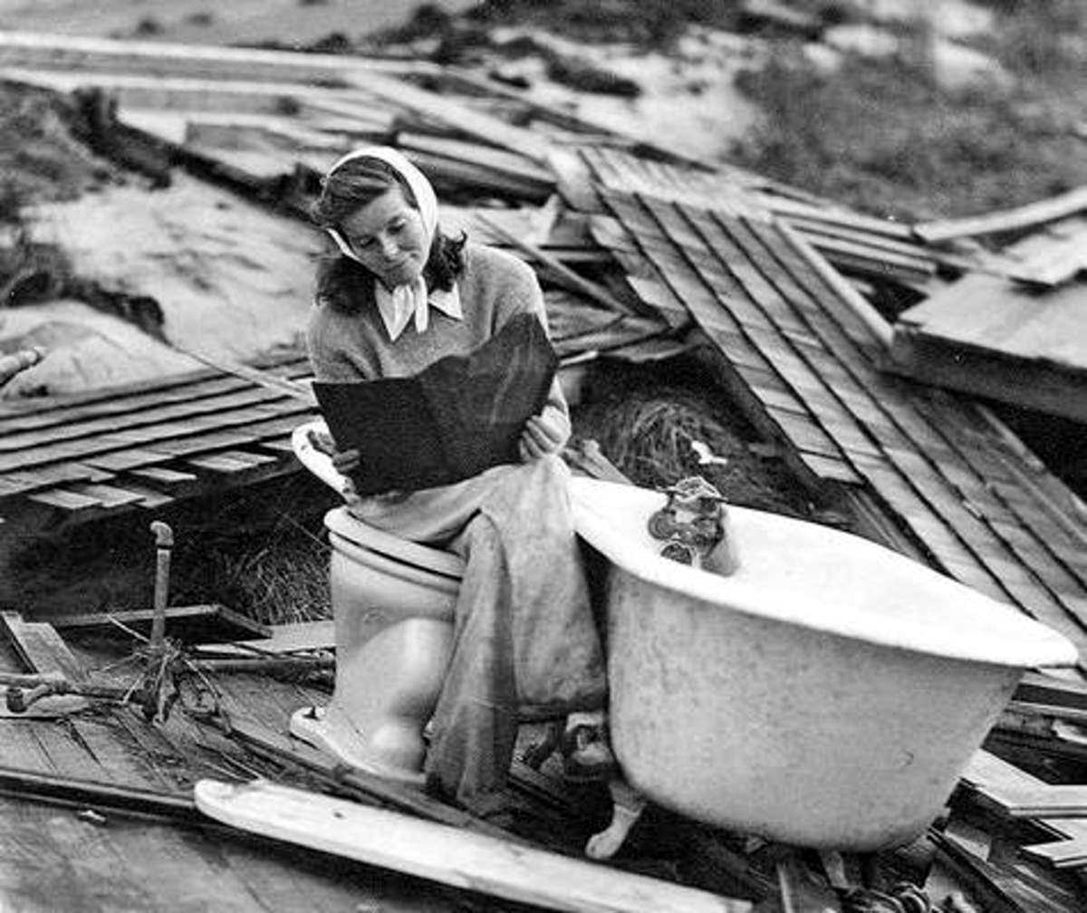 #1 Katharine Hepburn searching through the debris of her Fenwick home after the Hurricane of 1938.