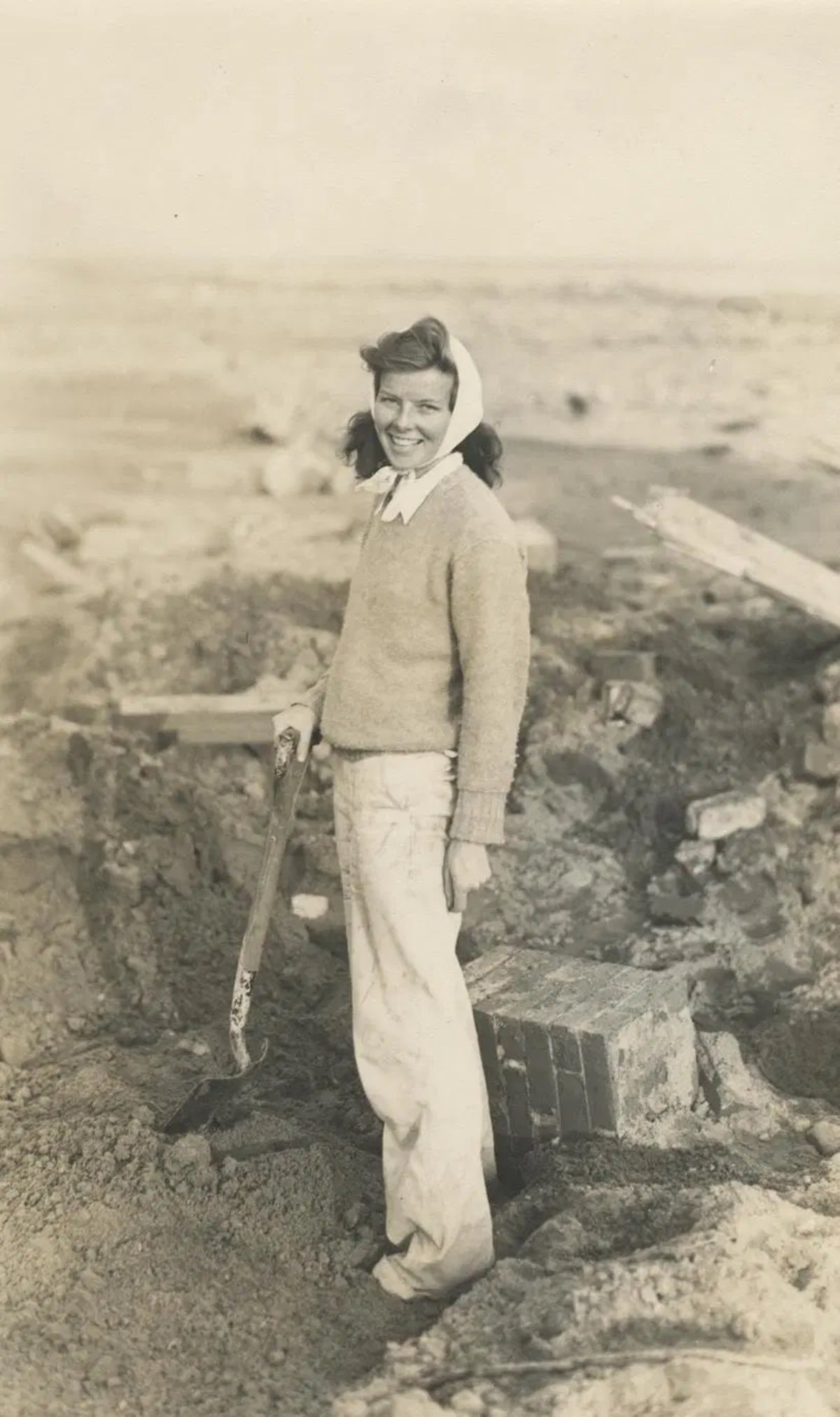 #4 Hepburn searching through debris of her family’s summer cottage after the hurricane of 1938.