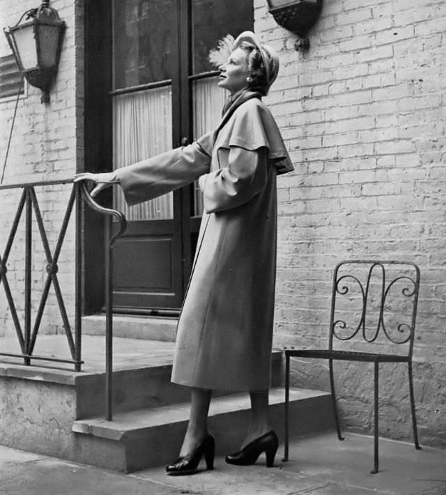 #28 Joan Pedersen in Miron gabardine coat with capelet by George Carmel at Saks Fifth Avenue, Harper’s Bazaar, 1948.