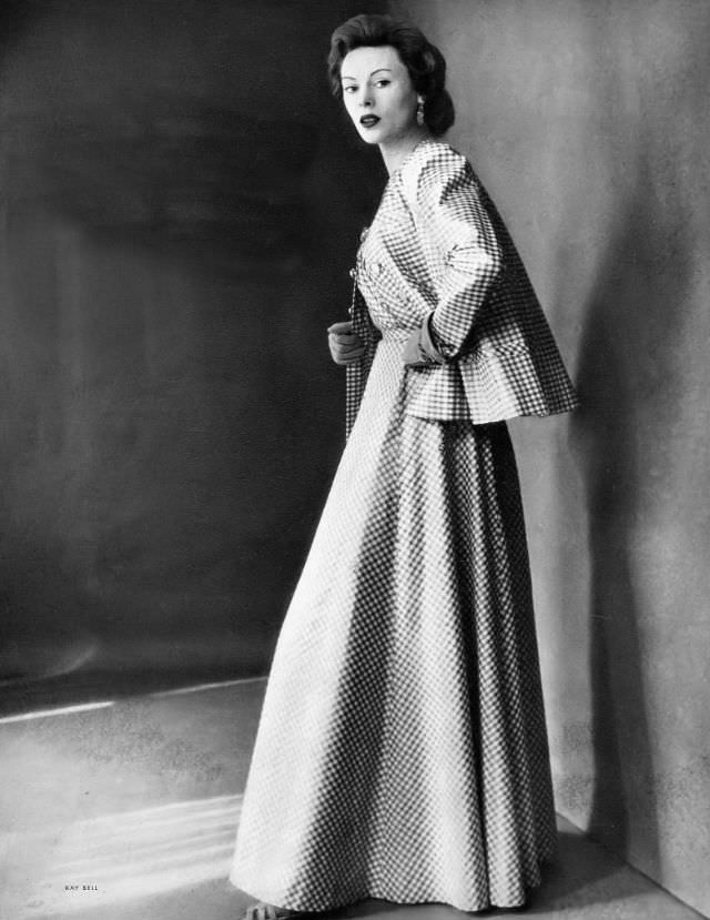 #34 Meg Mundy in long evening dress and jacket of off-white cotton checked in gold Lurex by Mainbocher, Harper’s Bazaar, 1948.