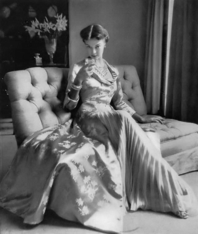 #44 Jean Patchett in tea-and-twilight coat of imported rayon brocade with cut-away pleated panel of silk chiffon from Bergdorf Goodman, Vogue, 1949.