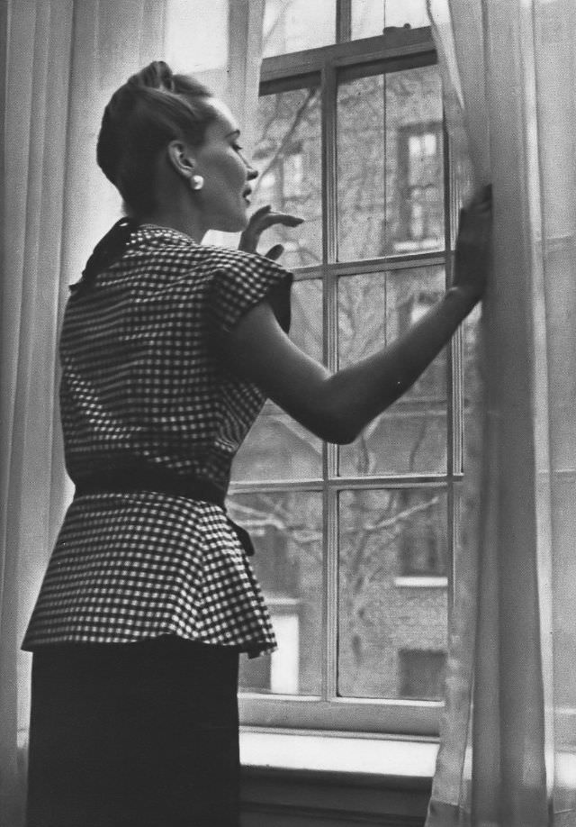 #9 Model in black-and-white checked gingham ripple peplum top over straight black rayon skirt at Bloomingdale, Vogue, 1945.