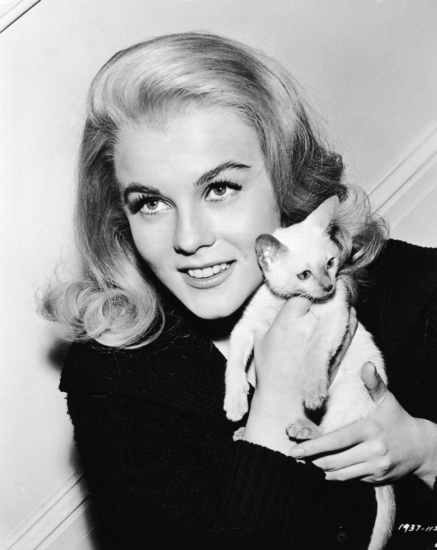 Ann-Margret holding a Siamese kitten for the film, ‘Kitten With a Whip,’ 1964.