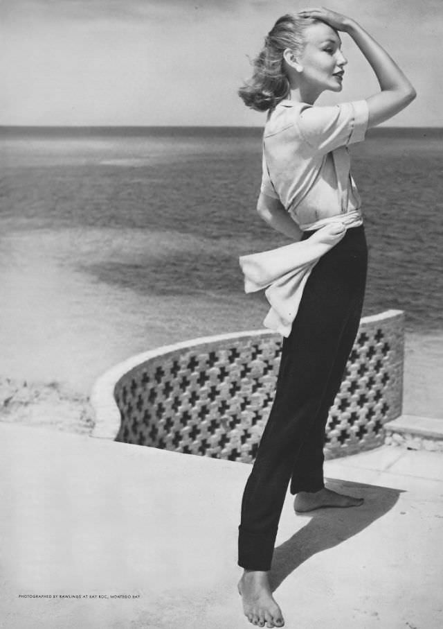 #27 Liz Pringle in navy linen slacks with pale blue rayon shirt and chiffon sash by B.H. Wragge, Jamaica, Vogue, May 1, 1953
