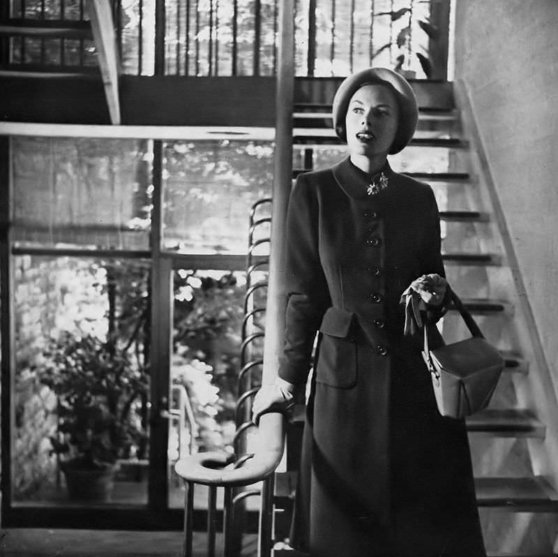 #19 Meg Mundy in beautifully proportioned princess coat with turn-back cuffs and flat pockets in cocoa brown Melton wool from Simplicity Pattern 2136, hat by Lilly Daché, Harper’s Bazaar, September 1947