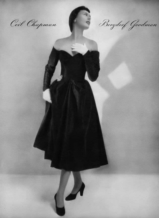 #29 Meg Mundy in off-shoulder black taffeta cocktail dress by Ceil Chapman at Bergdorf Goodman, Vogue, January 1, 1947