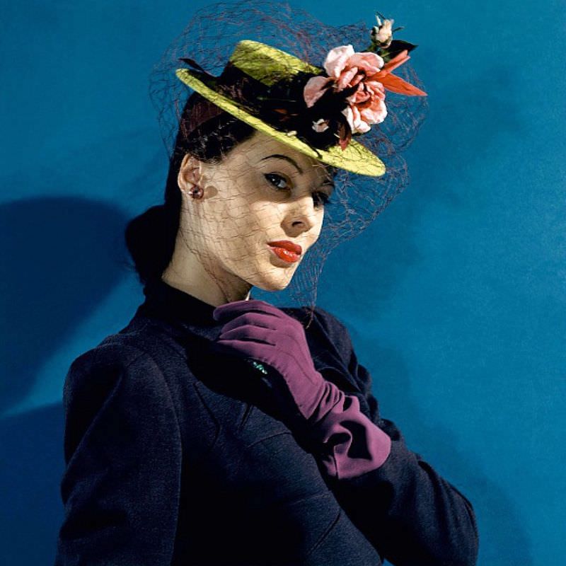 #5 Meg Mundy in chartreuse felt hat with roses and hummingbirds, purple gloves, and purple veil and ribbons, Vogue 1941