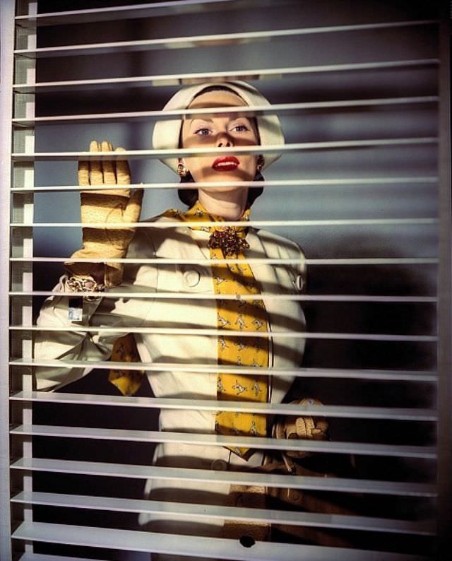 #8 Meg Mundy in white summer suit with yellow terrier print cravat, Vogue 1944