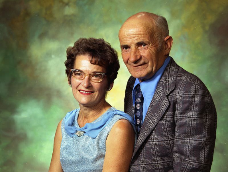 #18 Mr and Mrs James Miller. Mrs Miller is wearing a light blue, sleeveless top. Mr Miller is wearing a light blue shirt with a tie and dark-colored plaid sports coat, September 15, 1973
