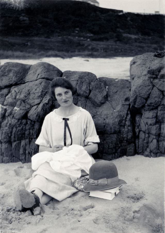 #1 A young lady in a light-colored dress posing on a beach on an overcast day.