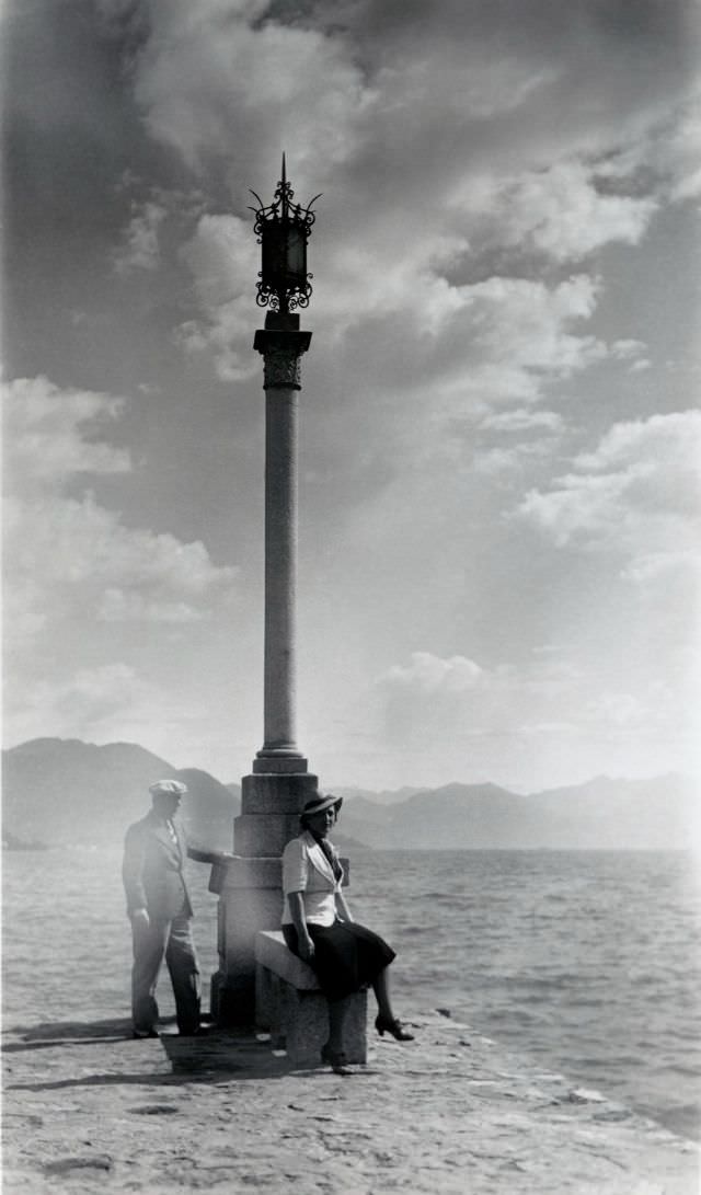 #11 A stylish couple posing next to an elaborate lamp post at the waterfront, 1935