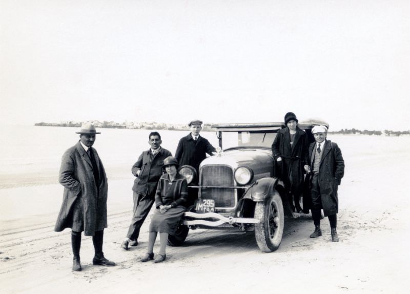 #2 A company of six posing with a 1926 Studebaker Phaeton on a beach in wintertime, December 9, 1927