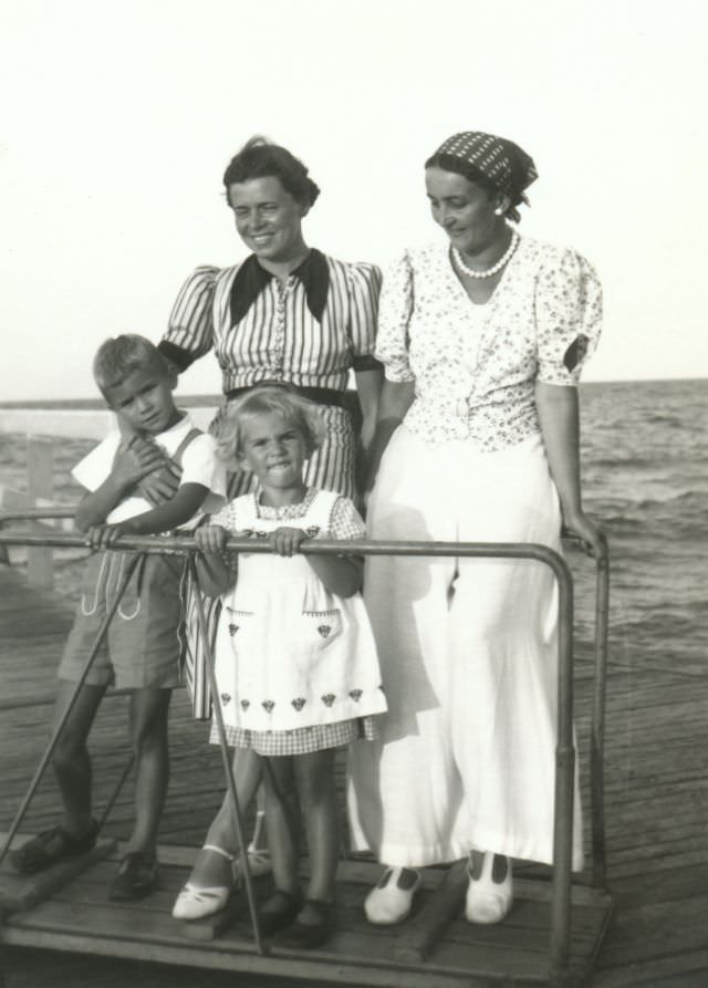 #20 Two ladies and two children posing on a landing stage. Originally the photograph comes from the city of Breslau, today known by its Polish name of Wroclaw, 1938