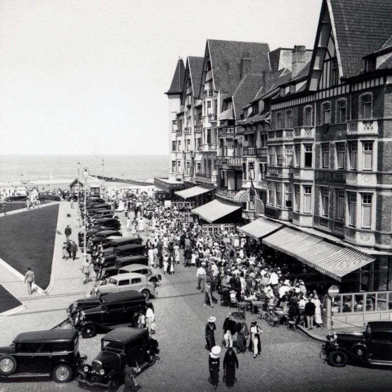 #8 A seaside promenade bustling with an elegant crowd on a sunny day.