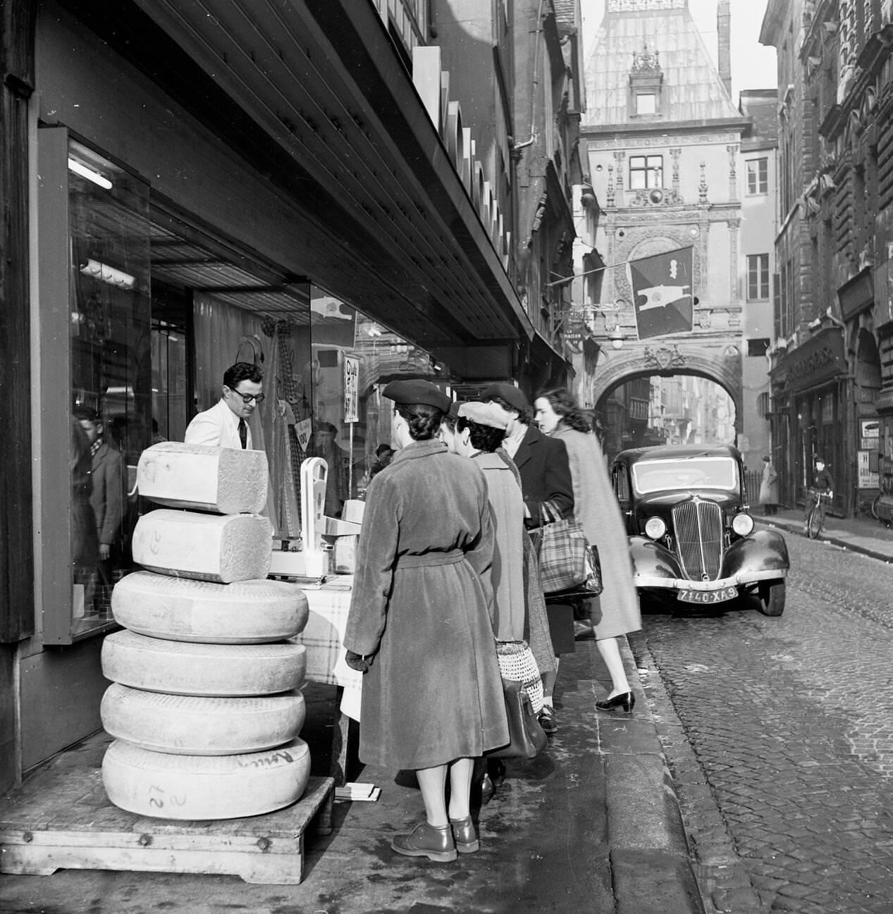#11 1950s: Female French Shoppers in Rouen Study Cheese Slices on Sale, France
