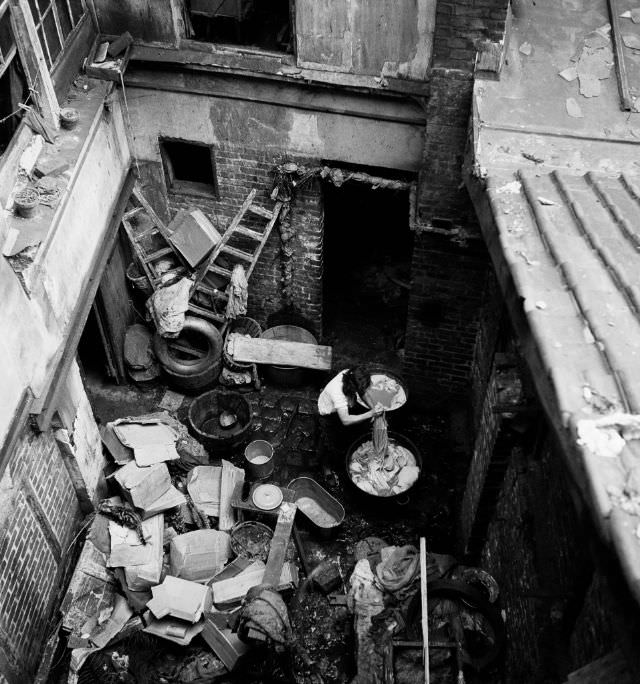 #66 Woman doing laundry in the courtyard of 3, rue Marin-le-Pigny, Rouen, September 1951