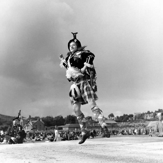 #11 In Stewart Tartan an Aberdeen lass competed in a championship Highland dancing contest held each year at the Cowal gathering at Dunoon. Other events included piping and the fling.