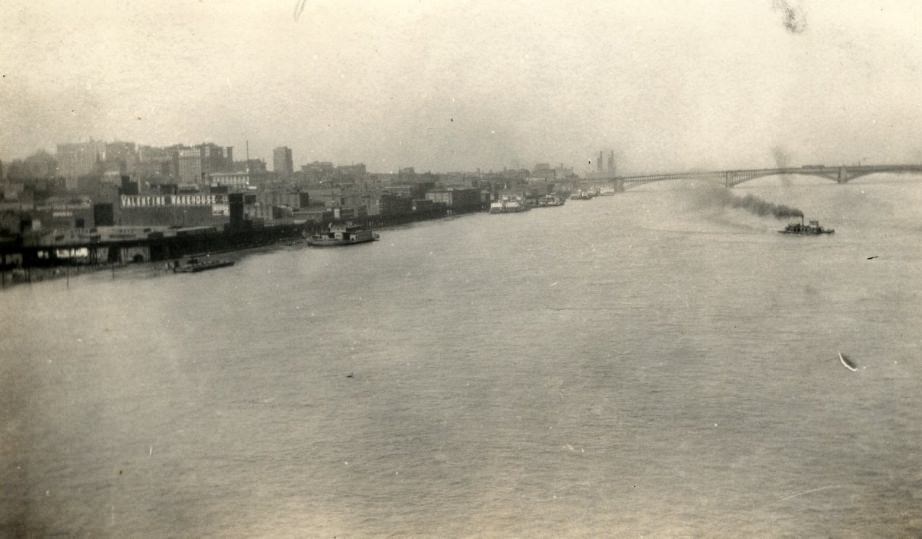 #7 View of the St. Louis riverfront looking north from a bridge, with the Eads Bridge in the distance, Valentine Warehouse and elevated railroad in the foreground, 1927.