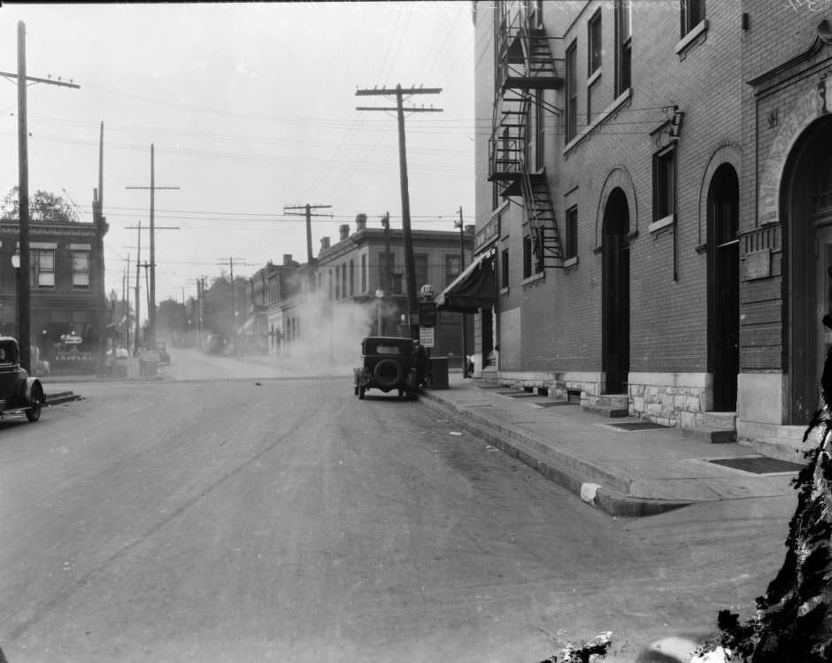 #181 South view on Compton Ave. towards the intersection with Park Ave., with Kroger store on the left and Theodore Bros. Golden Bee Chocolate Co. on the right, 1925