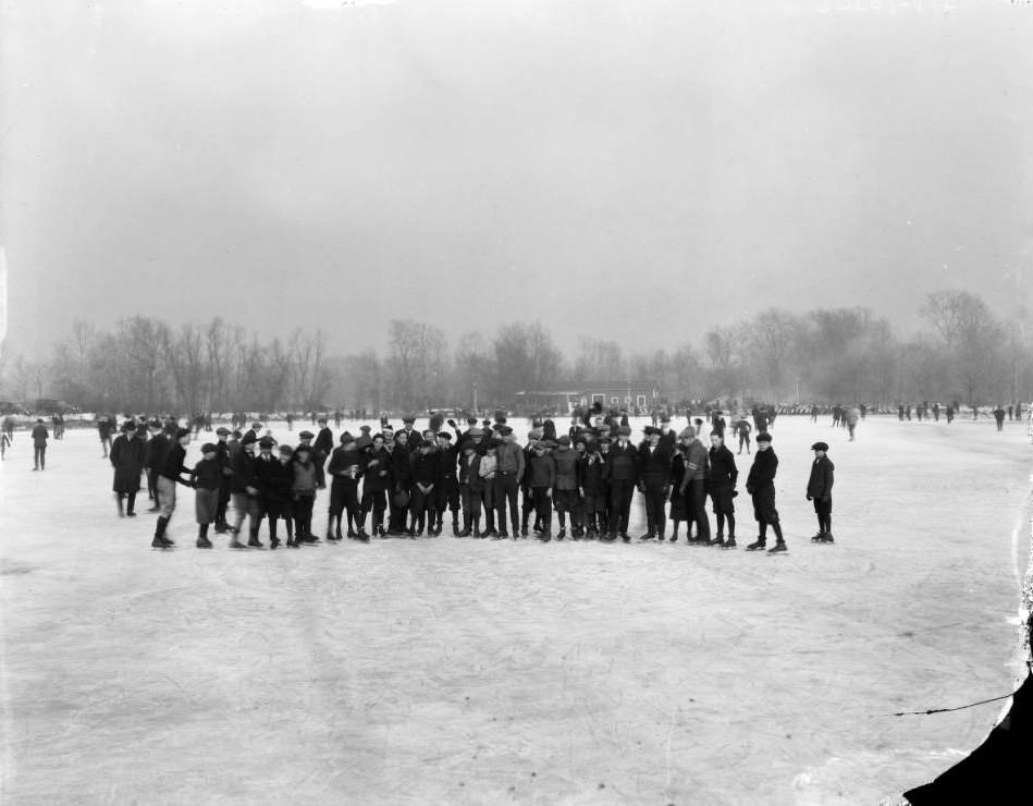 #72 Group of men and boys on skates posing on a frozen pond, 1927