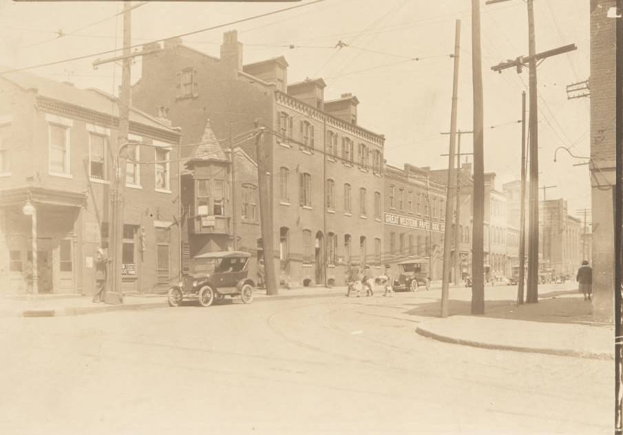 #17 Buildings near the intersection of 14th and Wash streets, with a policeman using a call box on the street corner, 1920