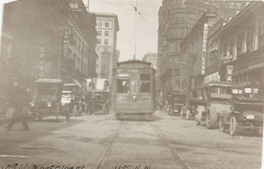 #90 Streetcar moving past automobile traffic on 8th Street, with signs for various theaters and establishments visible, 1920