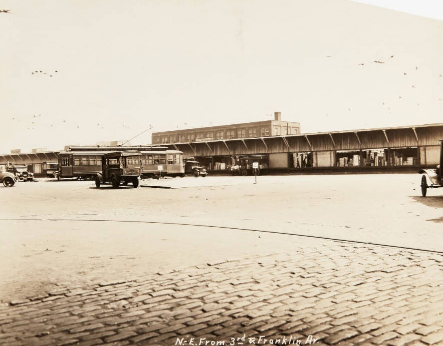 #91 Trucks and a streetcar loading at delivery docks located at Third Street and Franklin, 1920