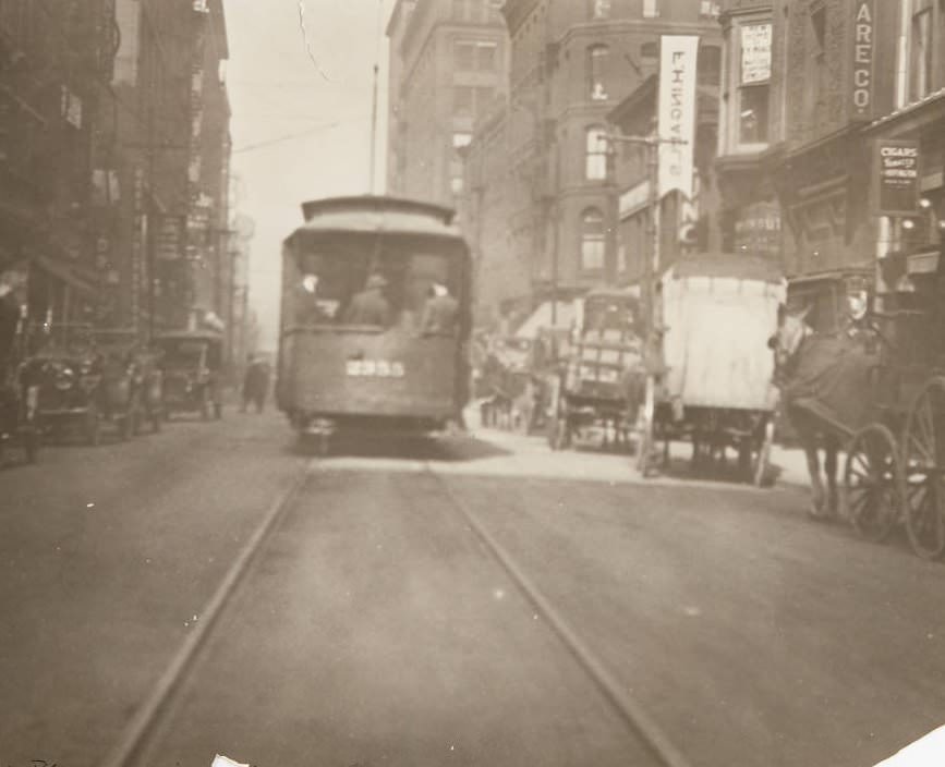 #95 Streetcar and horse-drawn carts moving along 7th Street near Olive, 1920