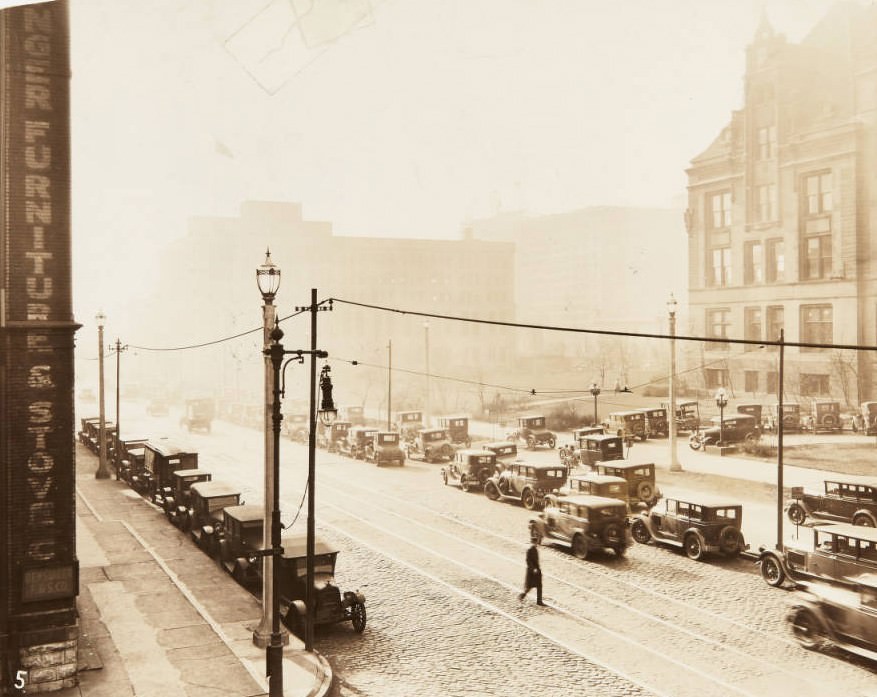 #21 View of 12th Street looking south from Walnut Street, with part of City Hall visible across the street and numerous cars parked along the street, 1920