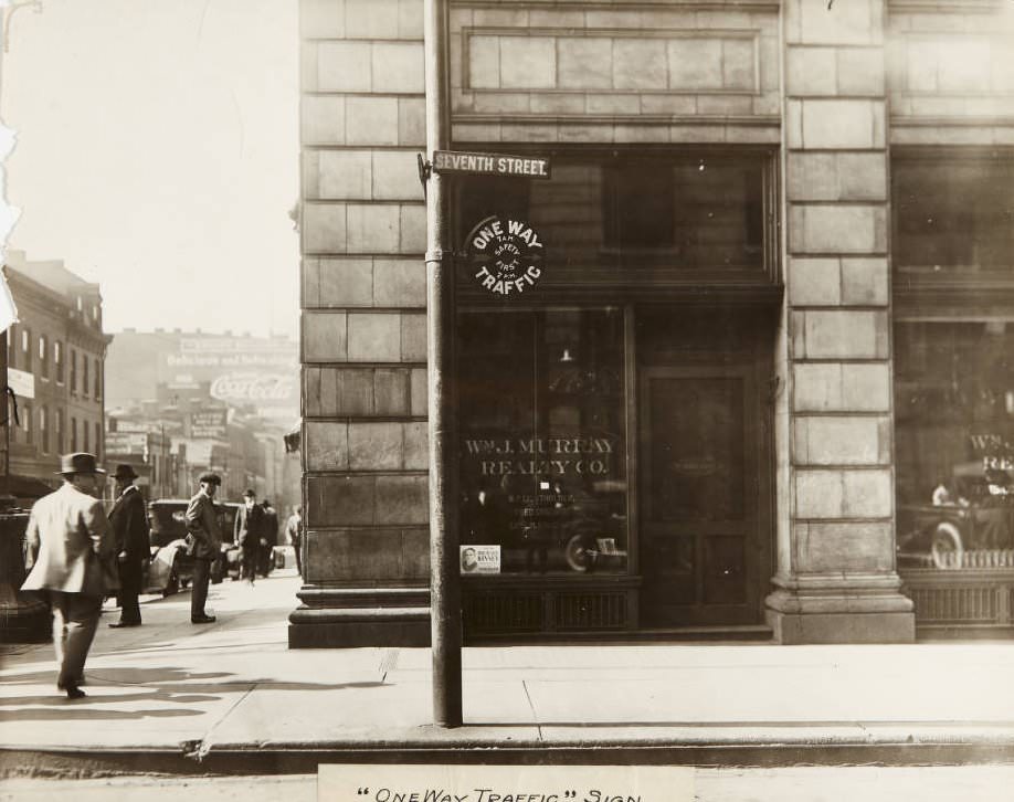 #104 Traffic sign near Seventh and Market Streets with Wm. J. Murray Realty Co. storefront in the background, 1920