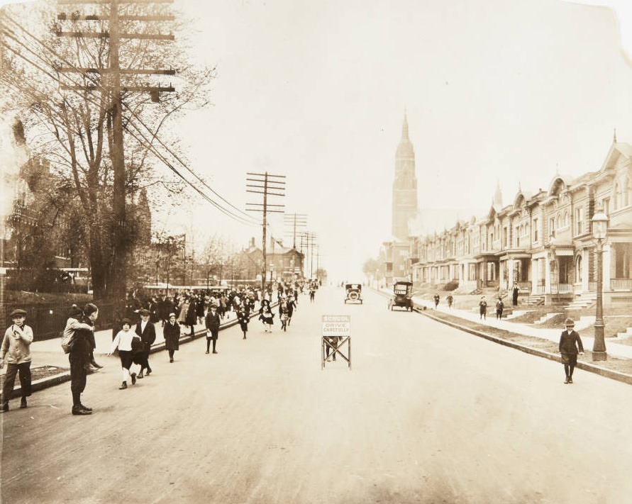 #28 Schoolchildren leaving Hempstead School after a long day of classes in the 5800 block of Minerva Street in 1920. St. Barbara’s Church can be seen in the distance.